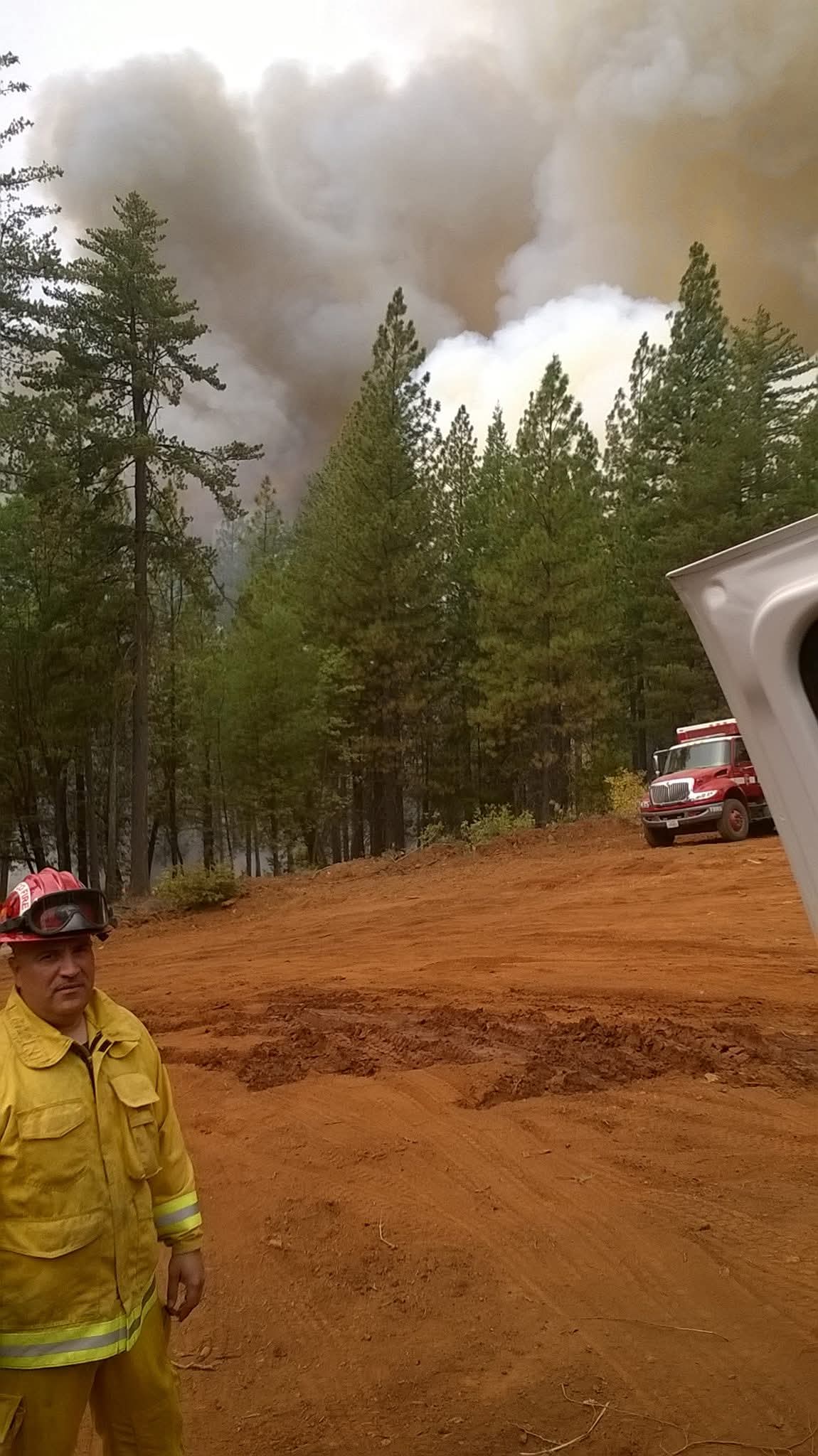 Andrew Caraballo in fire service uniform at a wildfire scene